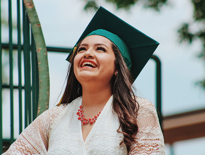 A student smiling on her graduation day.