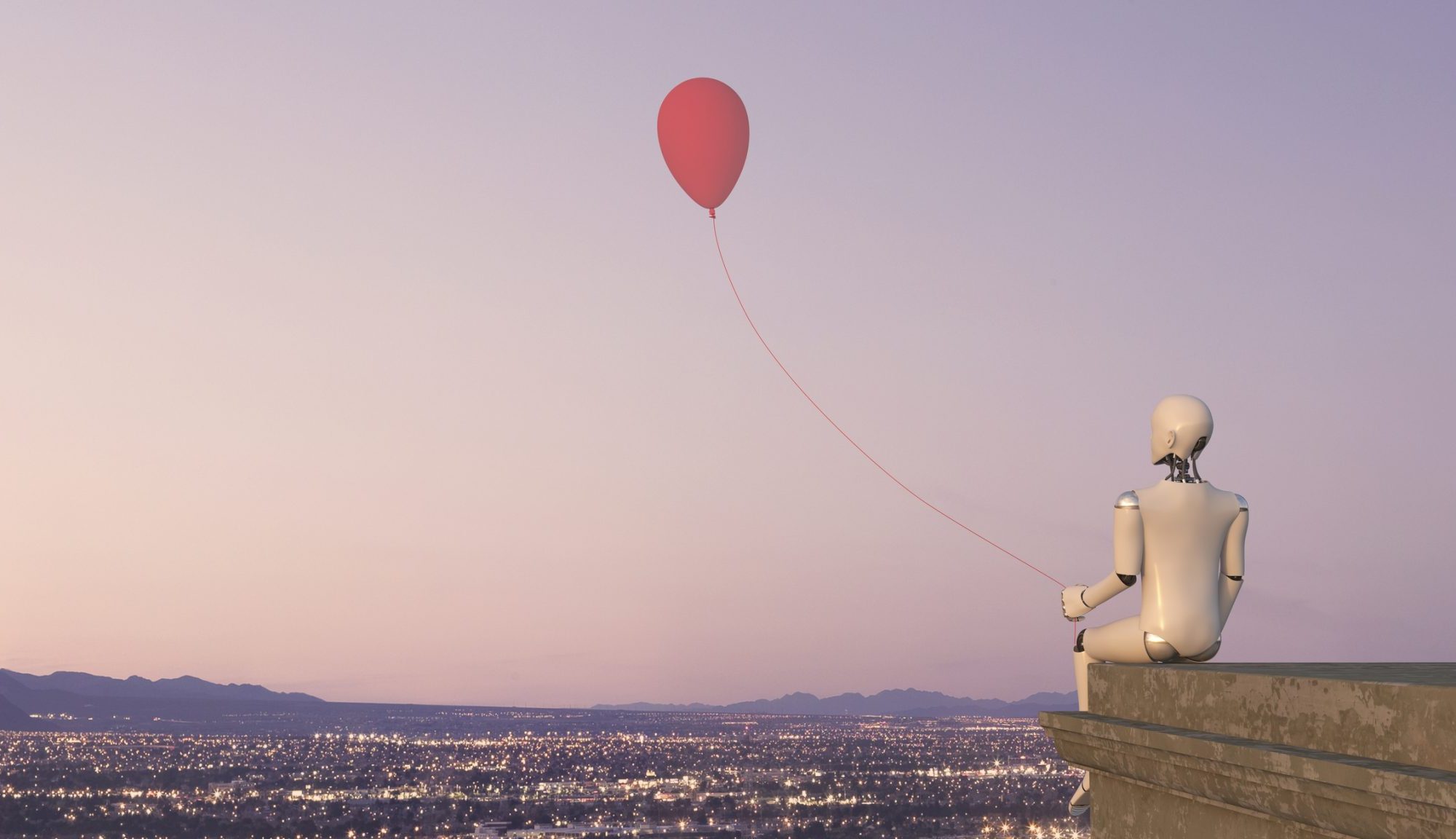 A white robot is sitting on the rooftop ledge of a building with the view of a city with lights, holding a red balloon.