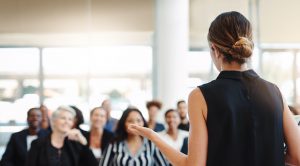 An audience is listening and engaged with a great speaker present.