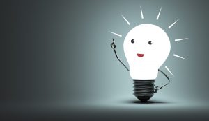 Here is a lightbulb glowing white with cartoon facial features and a metallic arm pointing upright; this is symbolic of innovation and ideas.