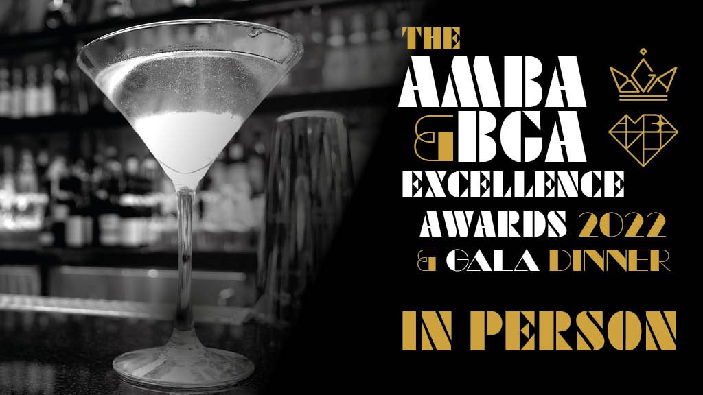 Black and white photo of a martini glass with white and gold text stating ' The AMBA & BGA Excellence Awards 2022 & Gala Dinner in person'.