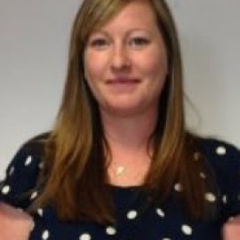 The Service Quality Manager, The University of Liverpool Management School and speaker from the AMBA & BGA Accreditation Forum smiling. The Manager has long, straight, medium brown hair and is wearing a black and white polka dot outfit with a pendant around the neck.