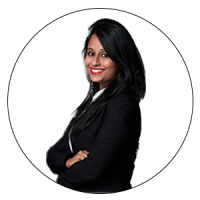 The CEO and Co-founder, Diversity & Inclusion Coach, BusinessWiz and Judge for AMBA & BGA Excellence Awards is smiling with her hands folded across her body. She has long black hair with brown eyes and bright red lipstick. Also, she is wearing a white top with a black blazer on top.