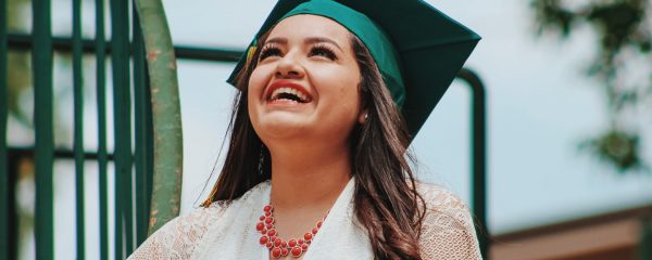 A person smiling on her graduation day.